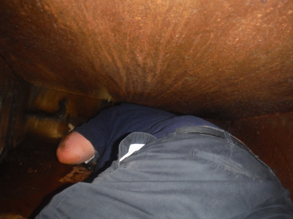 technician in ductwork - before