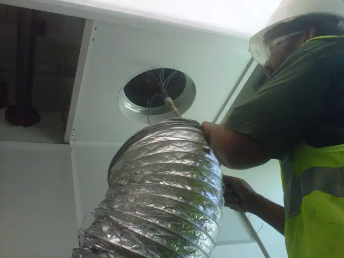 Technician Cleaning Ducting - during cleaning