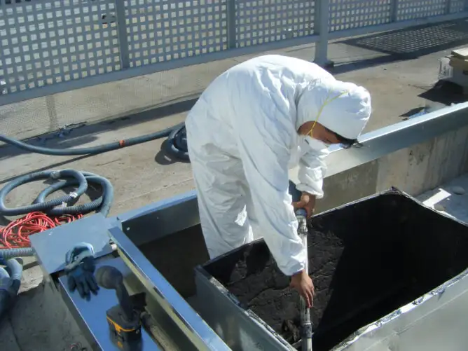 Technician cleaning ducting